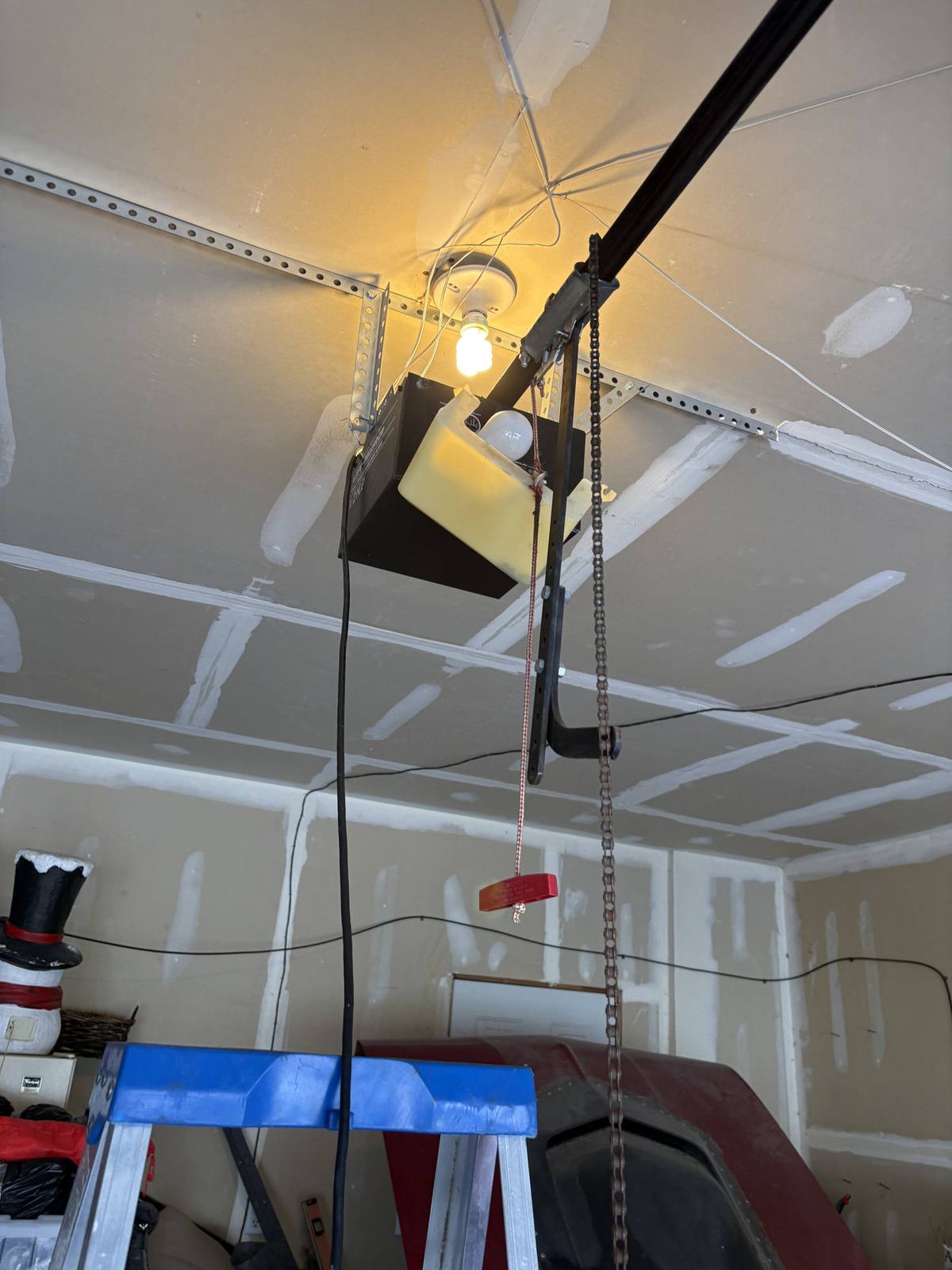 A chain drive opener above the door