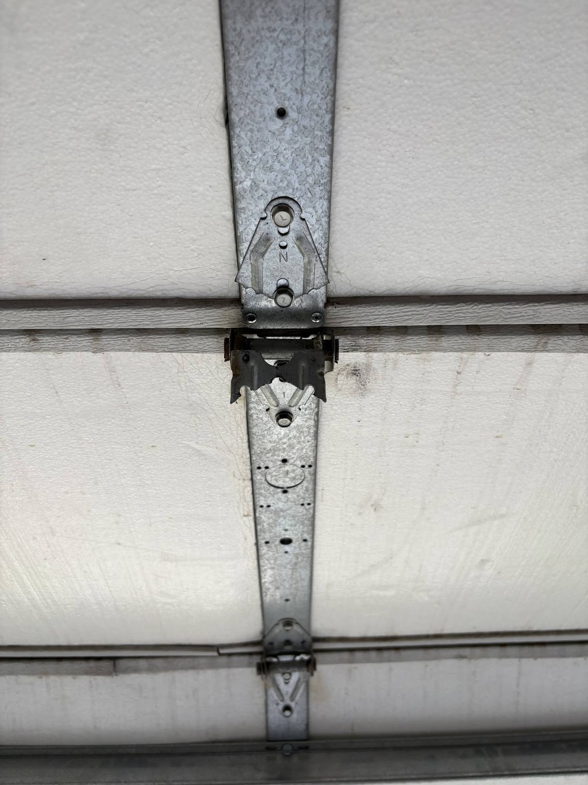 Hinges between two door sections